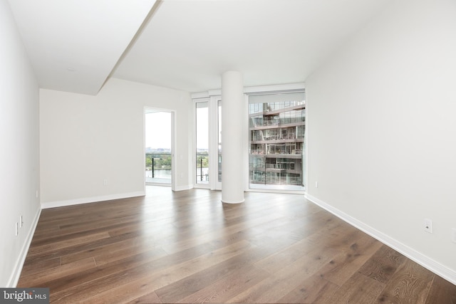 unfurnished living room featuring dark hardwood / wood-style floors