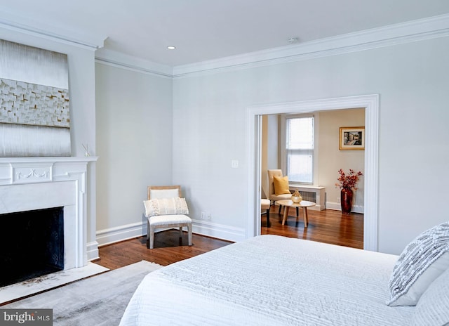 bedroom with dark hardwood / wood-style floors and ornamental molding