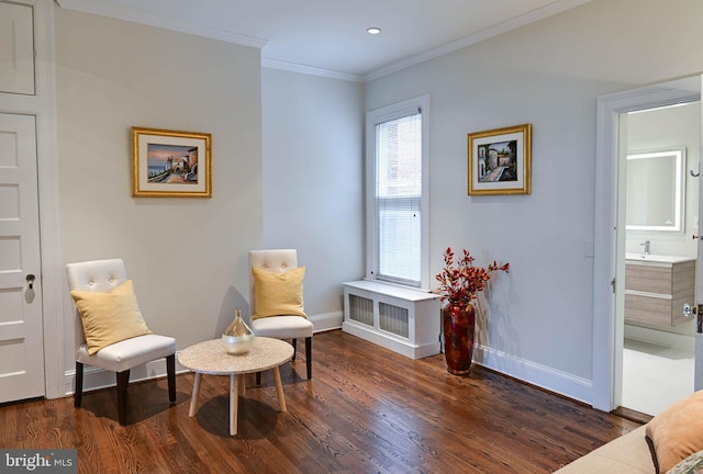 living area with crown molding and dark hardwood / wood-style flooring