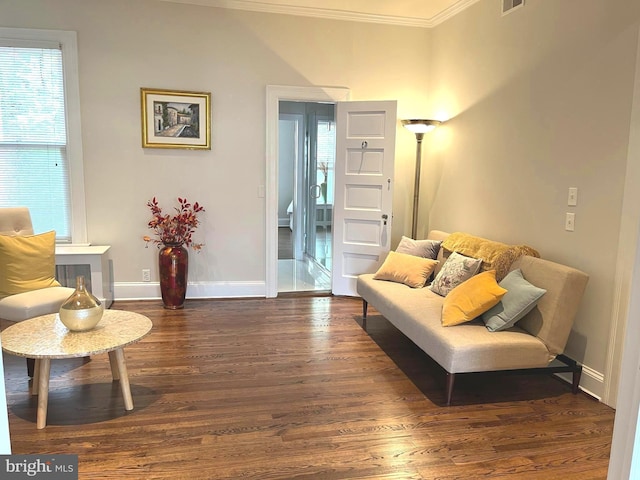 living room featuring crown molding and dark hardwood / wood-style flooring