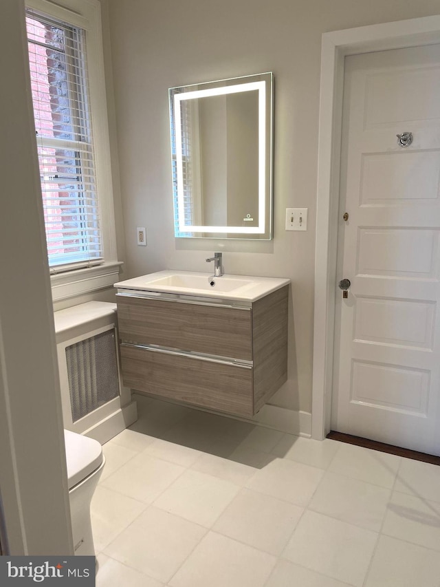 bathroom featuring tile floors, toilet, and vanity