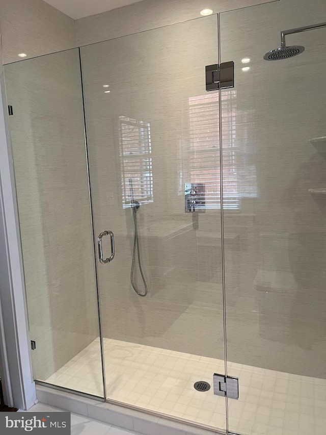 bathroom with a shower with shower door