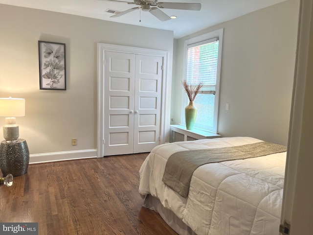 bedroom with a closet, ceiling fan, and dark hardwood / wood-style floors