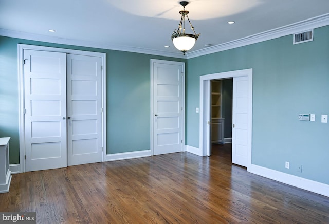 spare room with crown molding and dark hardwood / wood-style floors