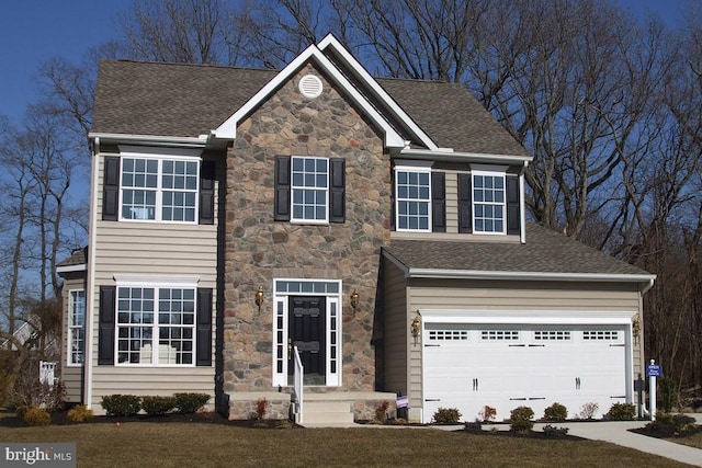 view of front of house with a front lawn and a garage