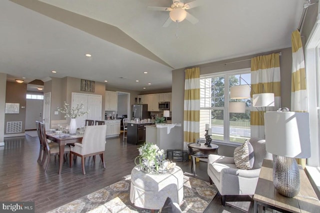 living room featuring lofted ceiling, dark hardwood / wood-style floors, and ceiling fan