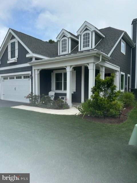 view of front of house with a porch and a garage