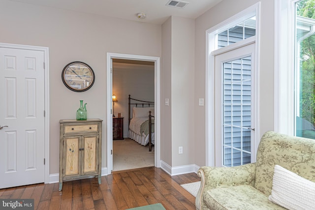 interior space with dark hardwood / wood-style flooring and a healthy amount of sunlight