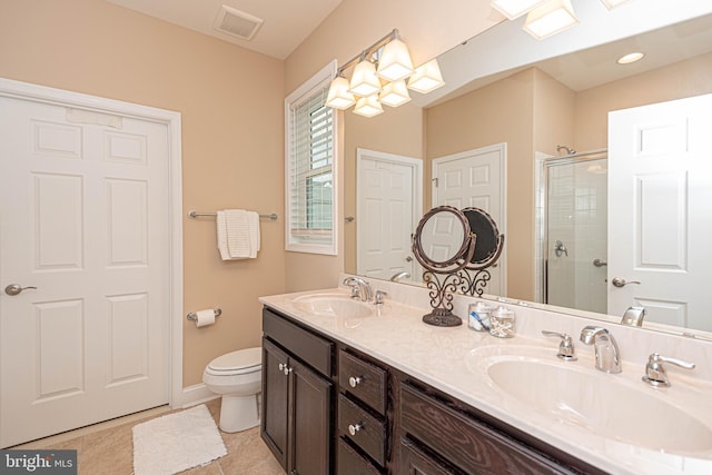 bathroom featuring vanity, tile patterned flooring, toilet, and an enclosed shower