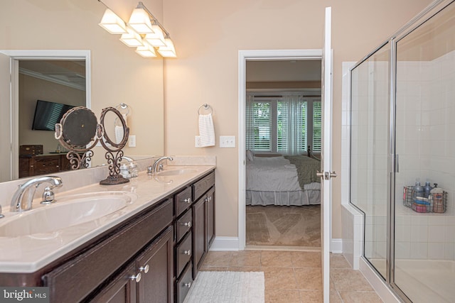 bathroom featuring tile patterned flooring, an enclosed shower, and vanity