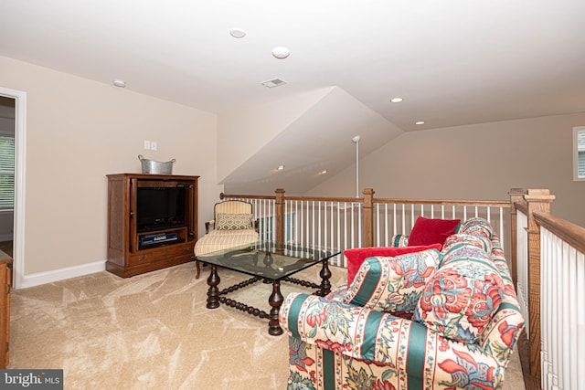 sitting room with light colored carpet and vaulted ceiling