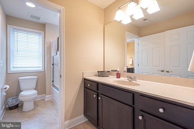 full bathroom featuring tile patterned flooring, vanity, toilet, and combined bath / shower with glass door