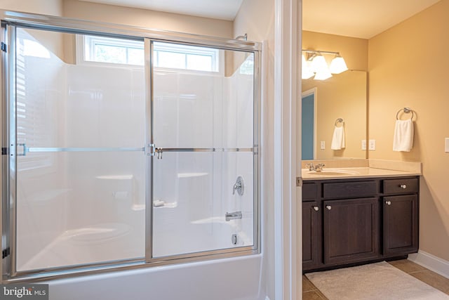 bathroom featuring tile patterned flooring, shower / bath combination with glass door, and vanity