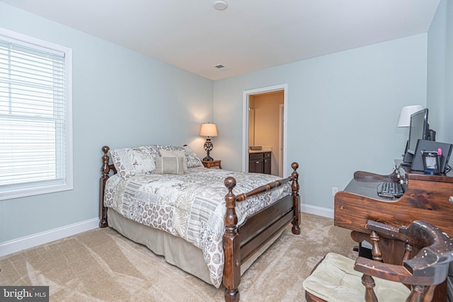 carpeted bedroom with ensuite bathroom