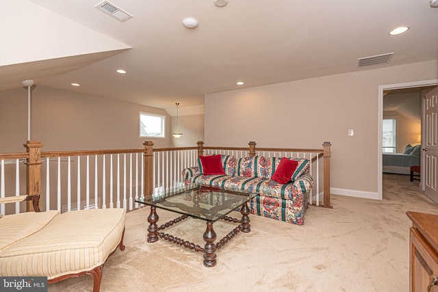 living room featuring light carpet and vaulted ceiling