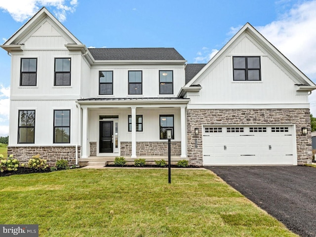 modern farmhouse style home featuring covered porch, a garage, and a front lawn