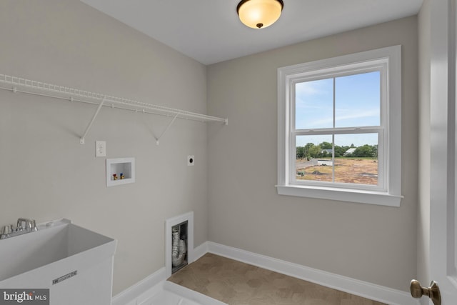 clothes washing area with hookup for a washing machine, electric dryer hookup, and sink