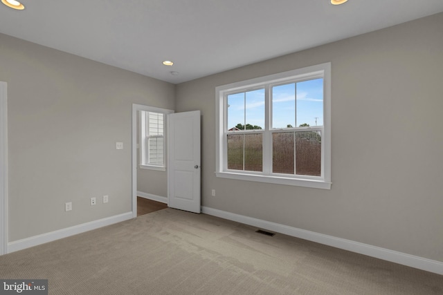 unfurnished room with light carpet