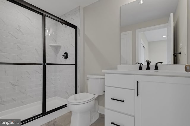 bathroom with vanity, toilet, and a shower with shower door