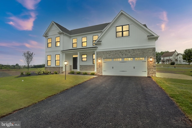 view of front of home featuring a yard and a garage