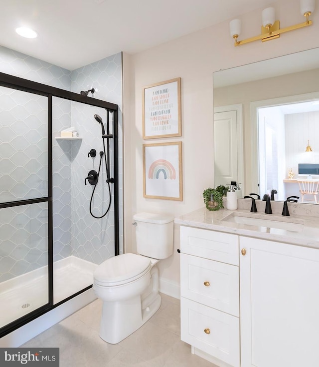 bathroom featuring tile patterned floors, vanity, toilet, and a shower with shower door