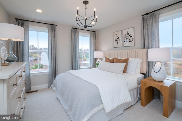 bedroom featuring multiple windows and light colored carpet