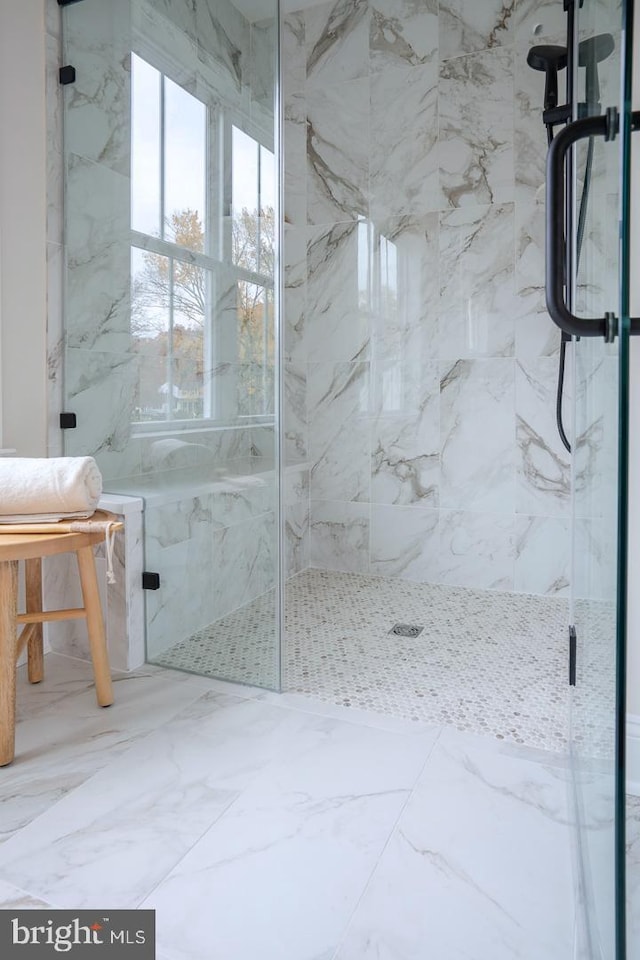 bathroom featuring a shower with door