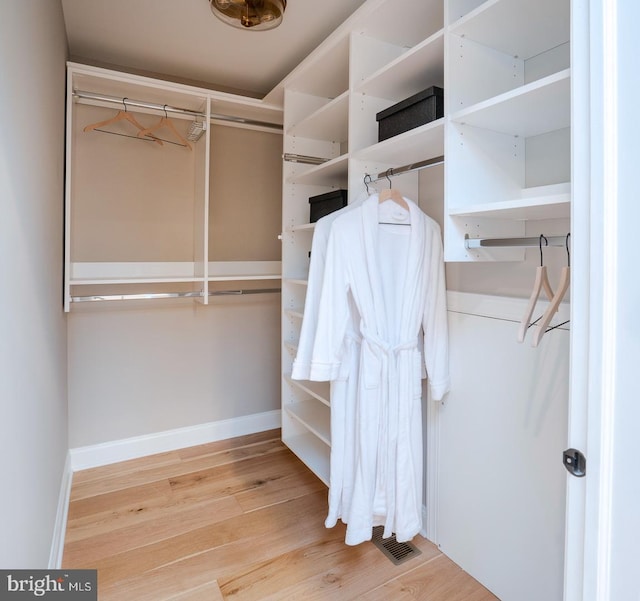 walk in closet featuring hardwood / wood-style flooring