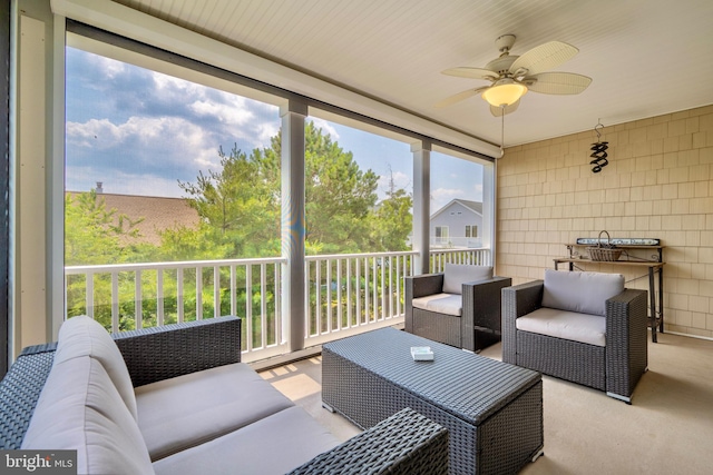 sunroom / solarium featuring plenty of natural light and ceiling fan