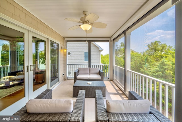 sunroom / solarium featuring plenty of natural light, ceiling fan, and french doors