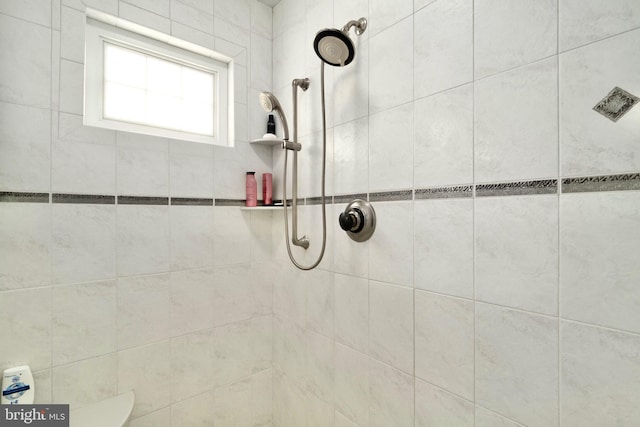 bathroom with a tile shower