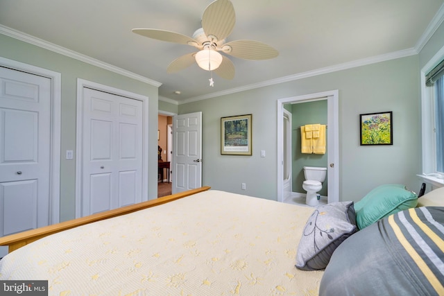 bedroom featuring ceiling fan, connected bathroom, ornamental molding, and multiple closets