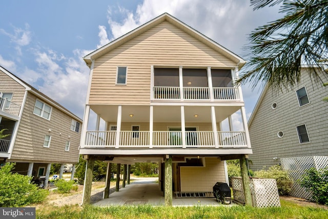 rear view of property with a balcony and a patio area