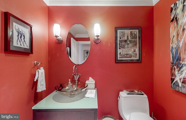 bathroom featuring vanity, crown molding, and toilet