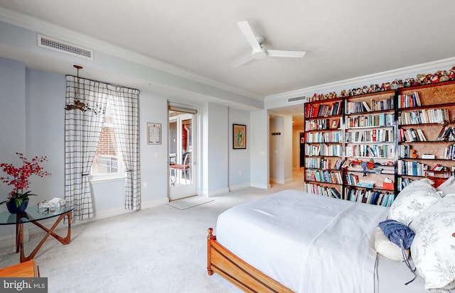 carpeted bedroom featuring ceiling fan and ornamental molding