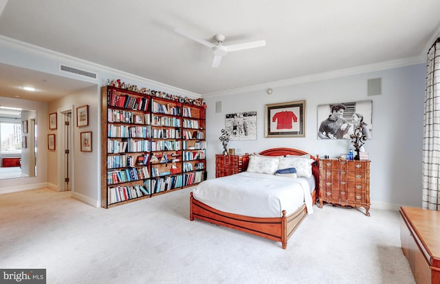 carpeted bedroom featuring ornamental molding and ceiling fan