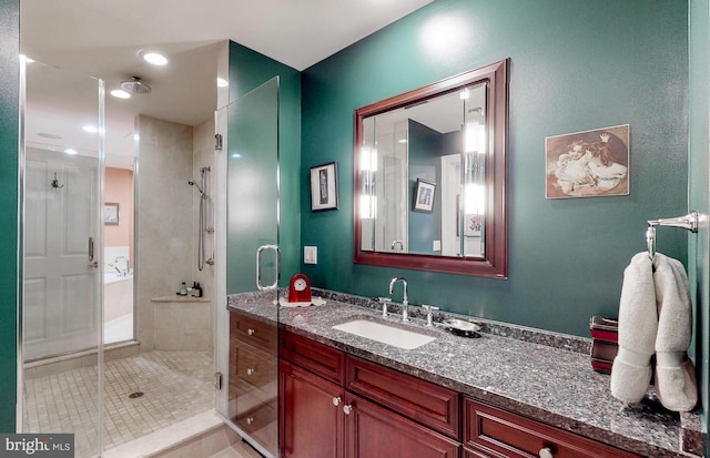 bathroom featuring vanity and a shower with shower door