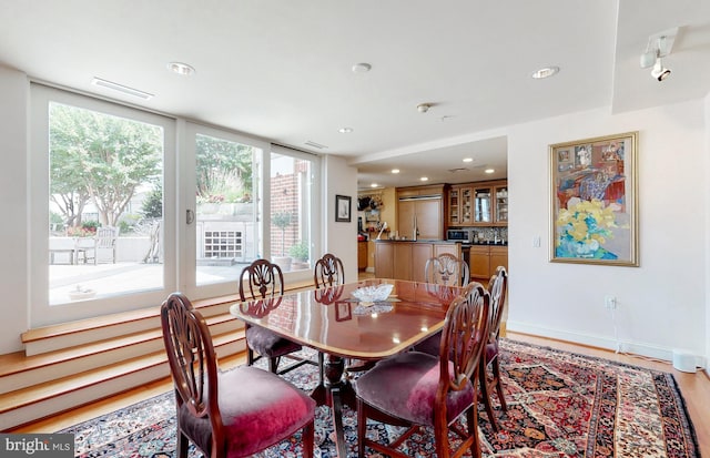 dining space with light hardwood / wood-style flooring and a wealth of natural light