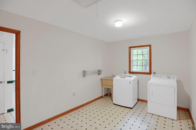 laundry area featuring light tile floors and washer and clothes dryer