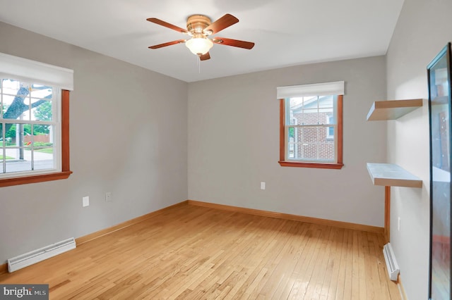 unfurnished room featuring a baseboard heating unit, light hardwood / wood-style floors, and ceiling fan