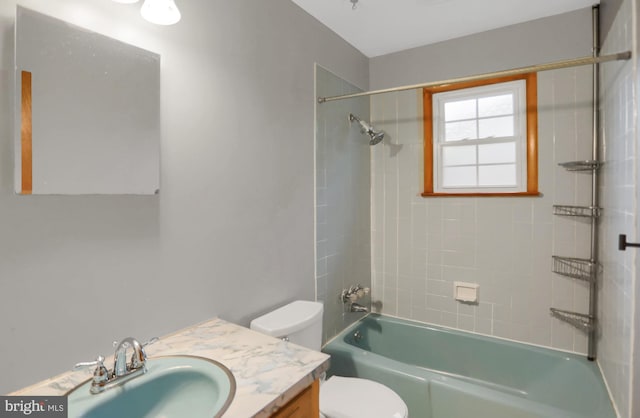 full bathroom featuring vanity, toilet, and tiled shower / bath