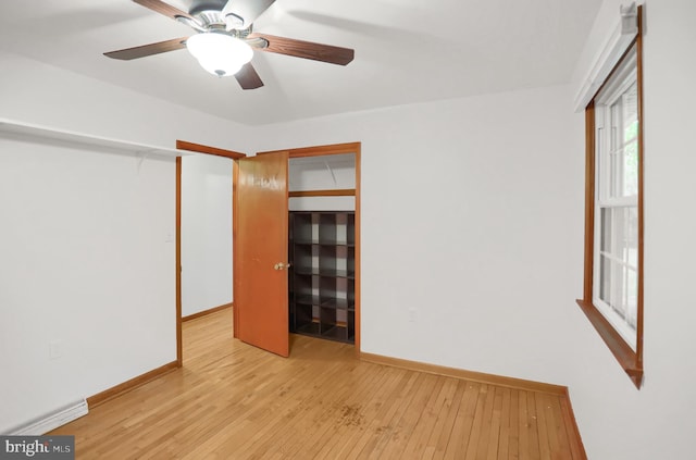 unfurnished bedroom with ceiling fan, light hardwood / wood-style floors, and a closet