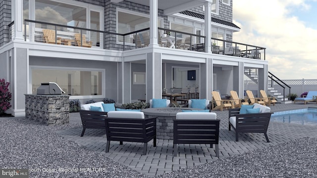 exterior space featuring a balcony and outdoor lounge area