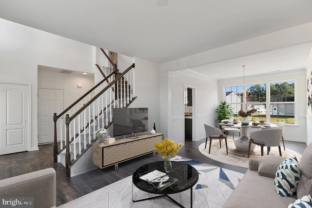 living room featuring a chandelier and dark hardwood / wood-style floors