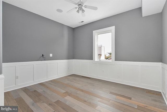 spare room with light hardwood / wood-style flooring and ceiling fan