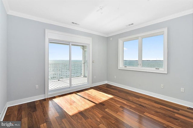 spare room featuring a water view, ornamental molding, and hardwood / wood-style flooring