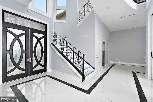 entryway with a high ceiling and french doors