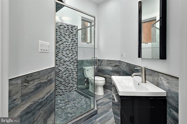 bathroom with plenty of natural light, toilet, and tile walls