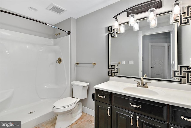 bathroom featuring walk in shower, tile patterned floors, vanity, and toilet