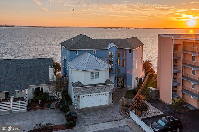 aerial view at dusk with a water view